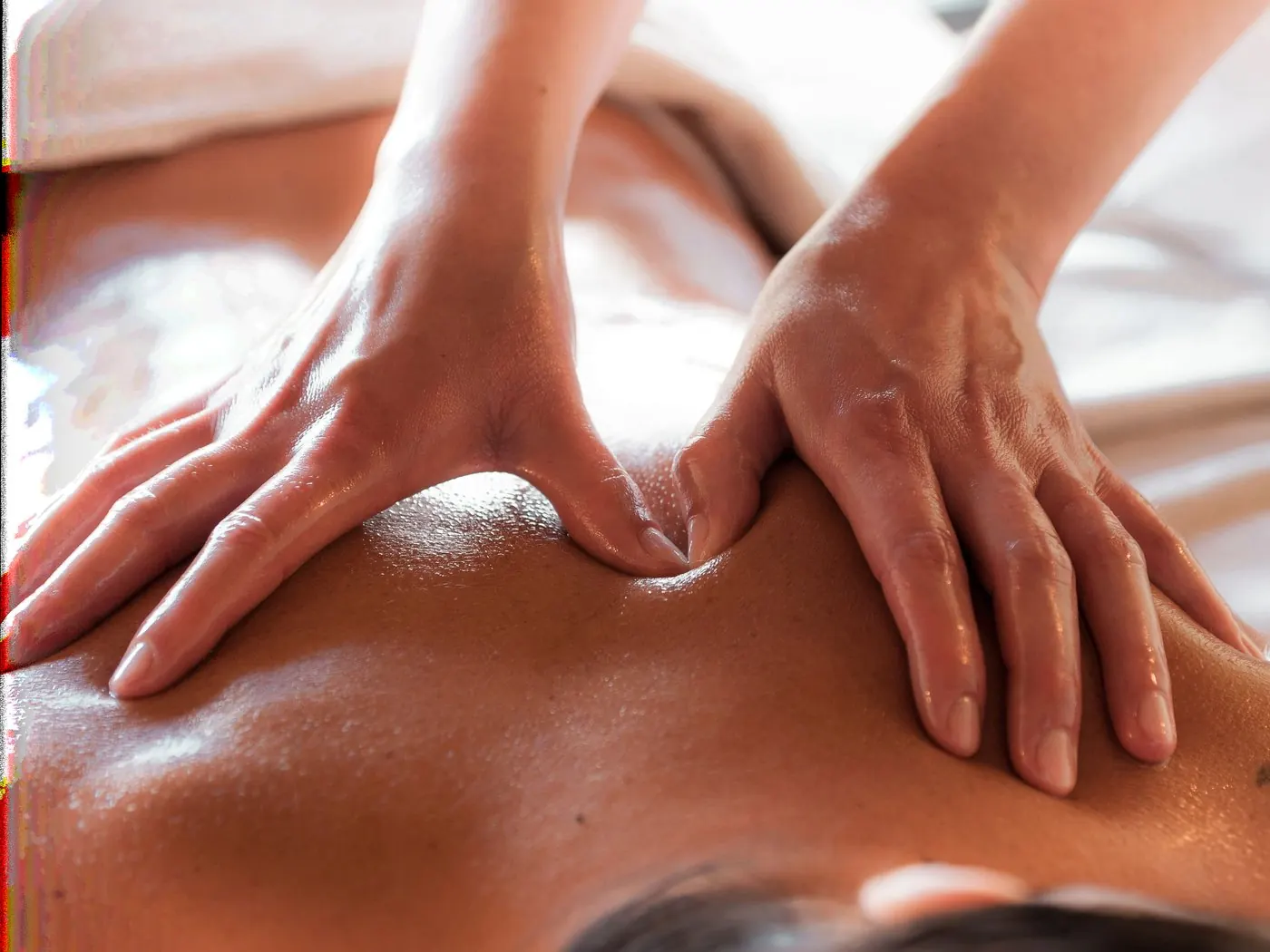Close-up of hands giving a deep tissue back massage
